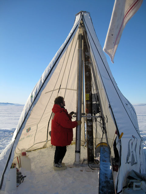 Person stands in tent.