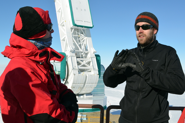 People converse in cold weather gear.