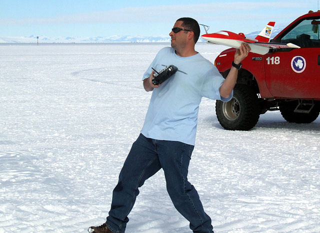 Person prepares to launch small airplane.