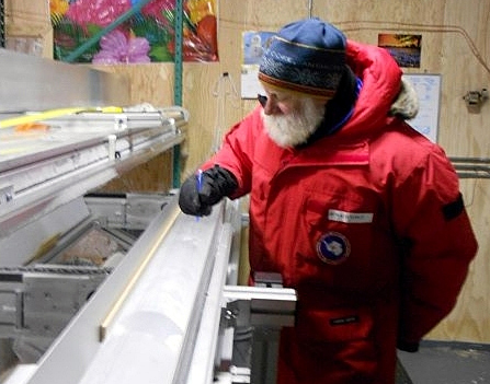 Person examines ice core.