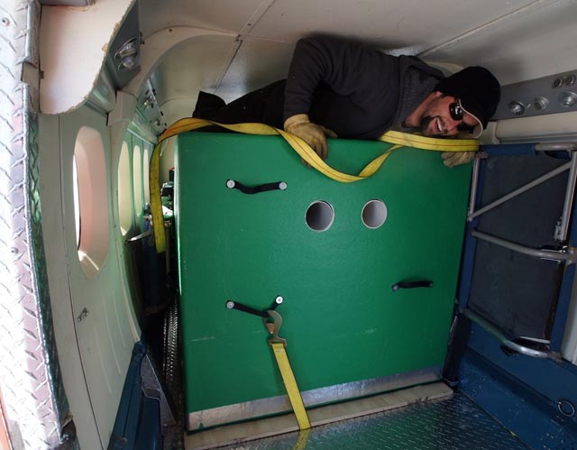 Person climbs over object in plane.