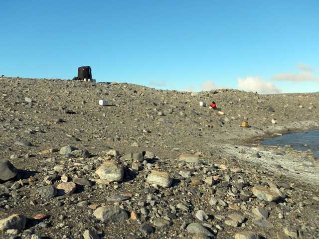 An object sits on top of rocky slope.
