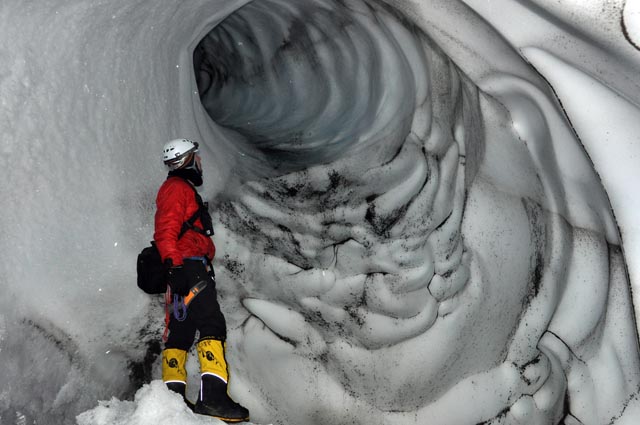 Person stares at hole in ice.
