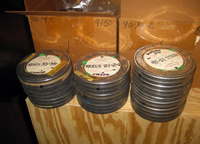Canisters of film sit on a box.