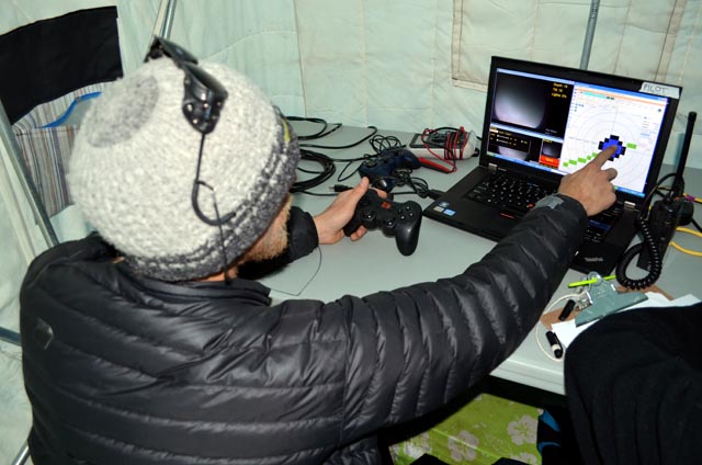 Person uses video game controller with laptop.