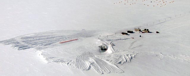 Aerial view of snow and buildings.