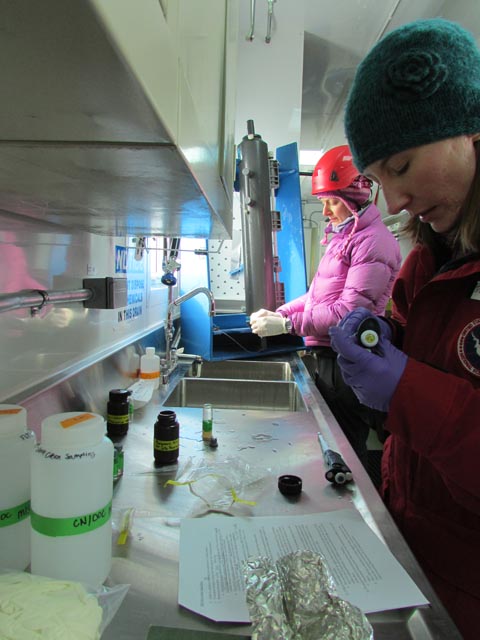 People work iin a lab wearing cold-weather gear.