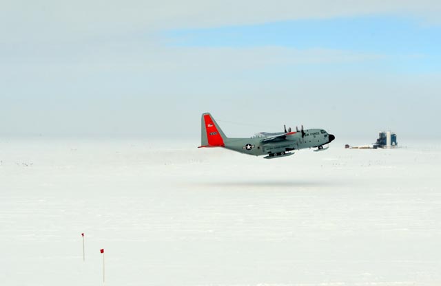 An airplane takes off from snow field.
