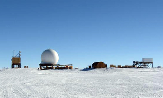 Small buildings stand on ice.