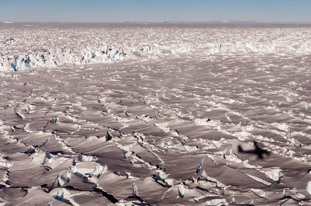 Heavily crevassed surface of ice.