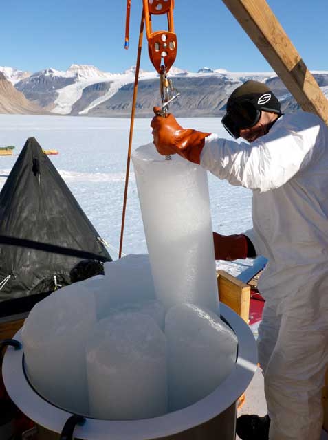 Person lowers ice core in big pot.