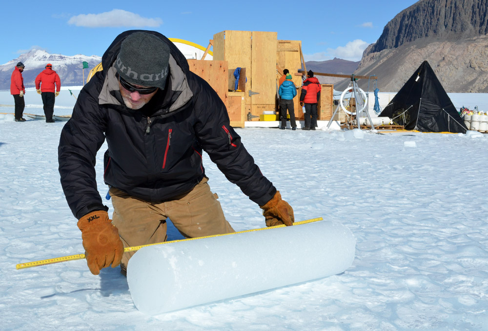 Person measures ice core.