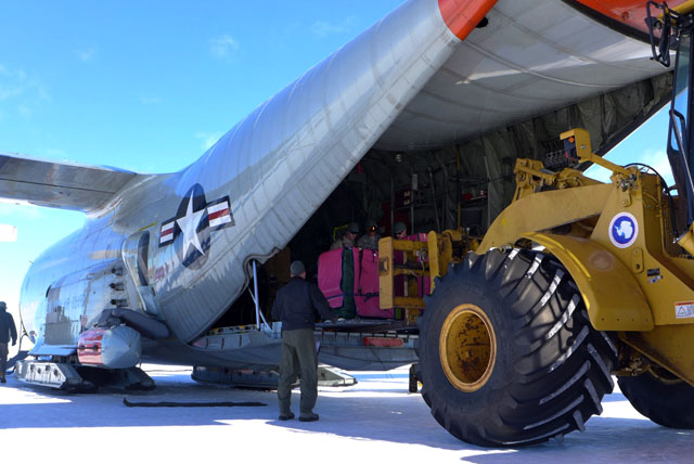 Machine loads cargo into a plane.