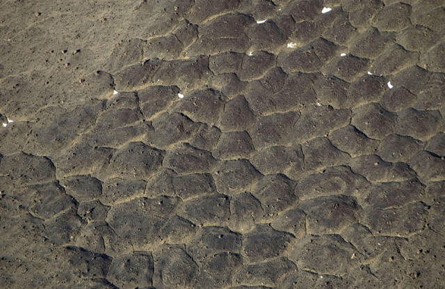 Aerial view of dusty, rocky landscape.