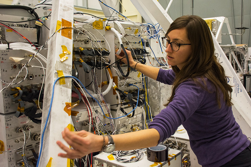 Researcher Nicole Duncan checks the wiring on GRIPS before its flight.