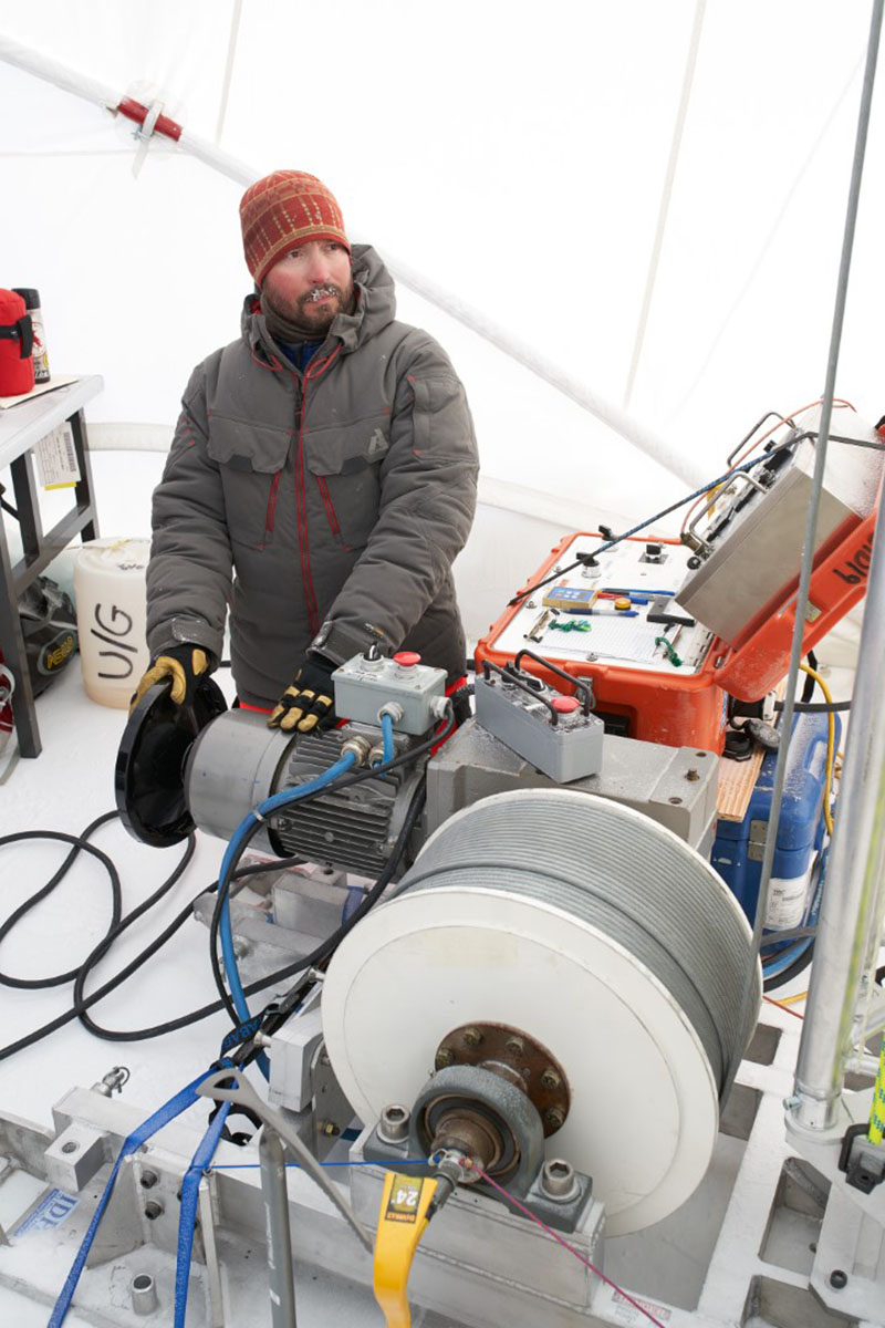 Driller Tanner Kuhl operates the drill boring into the ice and retrieving ice cores