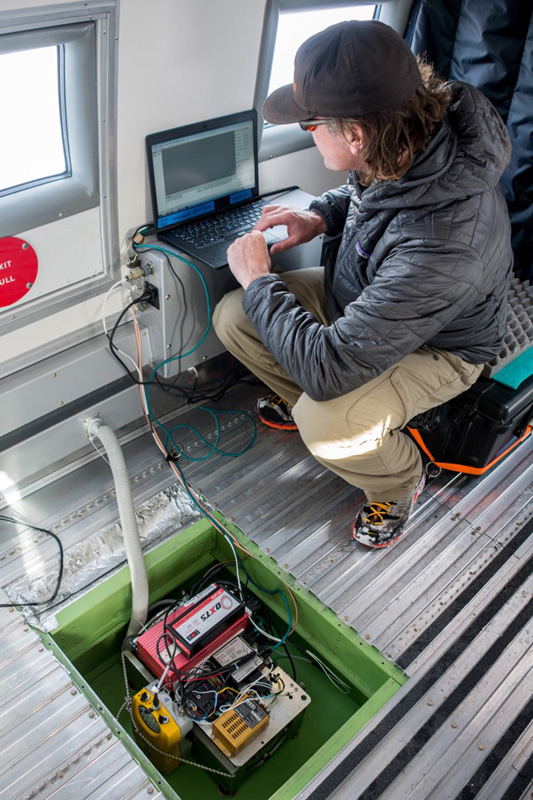 Christopher Larsen, of the University of Alaska, Fairbanks, installs the laser altimeter into the Basler