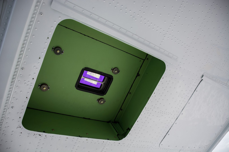 Underneath the plane, the installed laser altimeter peeks out through a specially-cut hole in the plane