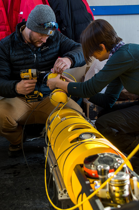 Matt Meister and Francis Bryson work to assemble the Icefin robot and prep it for launch.