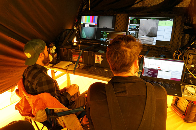 Charles Ramey (left) and Andy Mullen pilot the remote vehicle under the Erebus Ice Tongue from their portable mission control inside their tent.