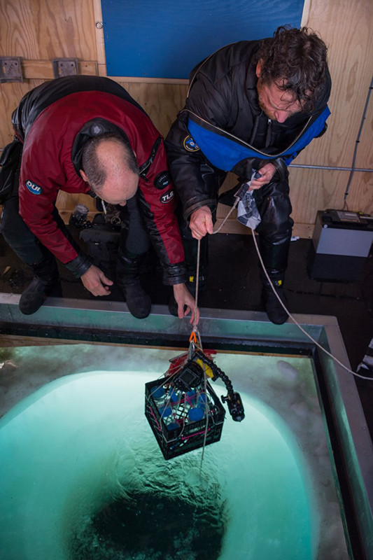 USAP divers Steve Rupp (left) and Rob Robbins help to pull in a milk crate full of sample vials