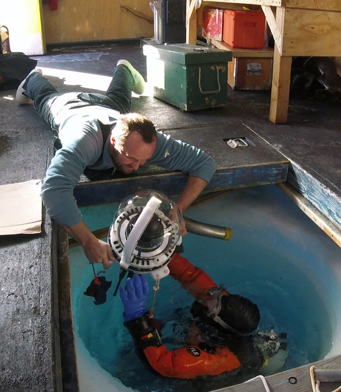 Biophysicist Konrad Meister (left) hands Paul Cziko the MOO camera to be installed on the sea floor