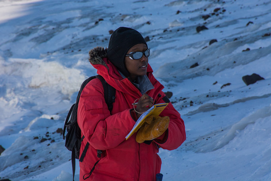 Hanna Asefaw takes down notes about the kinds of rocks they collected and their location