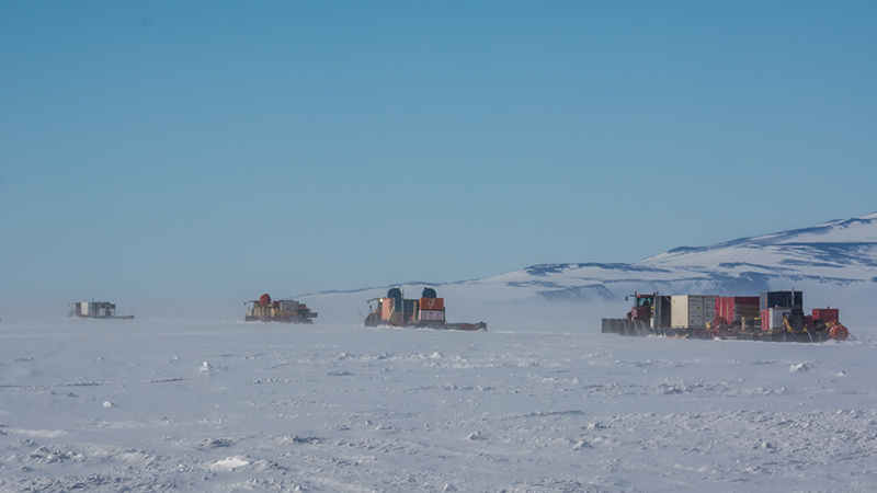 A fleet of tractors hauling gear and scientific equipment depart McMurdo Station bound for the Lake Mercer site. All together the tractors hauled more than a million pounds of cargo, 650 miles across the frozen West Antarctic Ice Shelf.