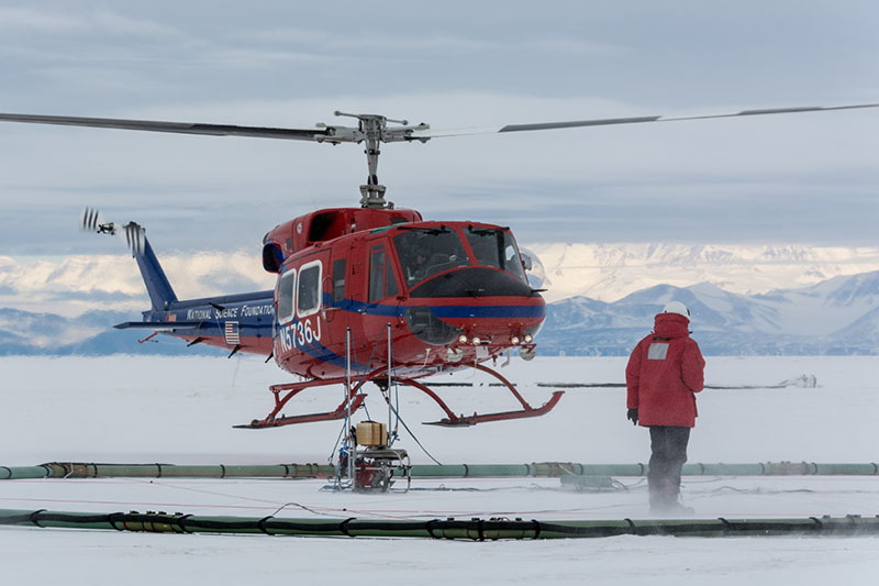 As the helicopter lifts off carrying SkyTEM, Lars Jensen makes sure the instrument gets off the ground safely