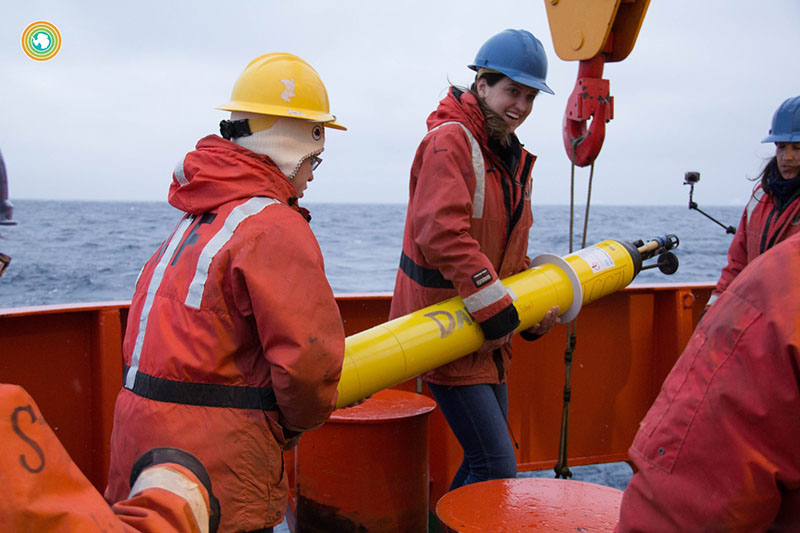 Researchers haul a SOCCOM float to the edge of the bow of the Research Vessel Nathaniel B. Palmer for deployment
