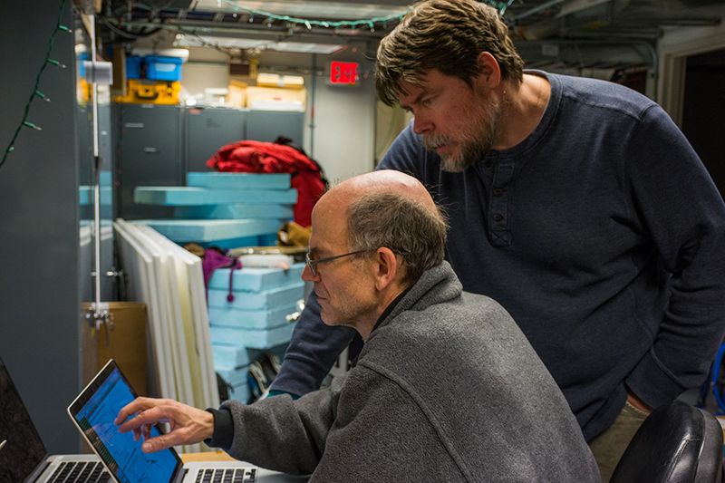 John Carlstrom (left) and Erik Nichols look over data from the South Pole Telescope during the installation of its new detector