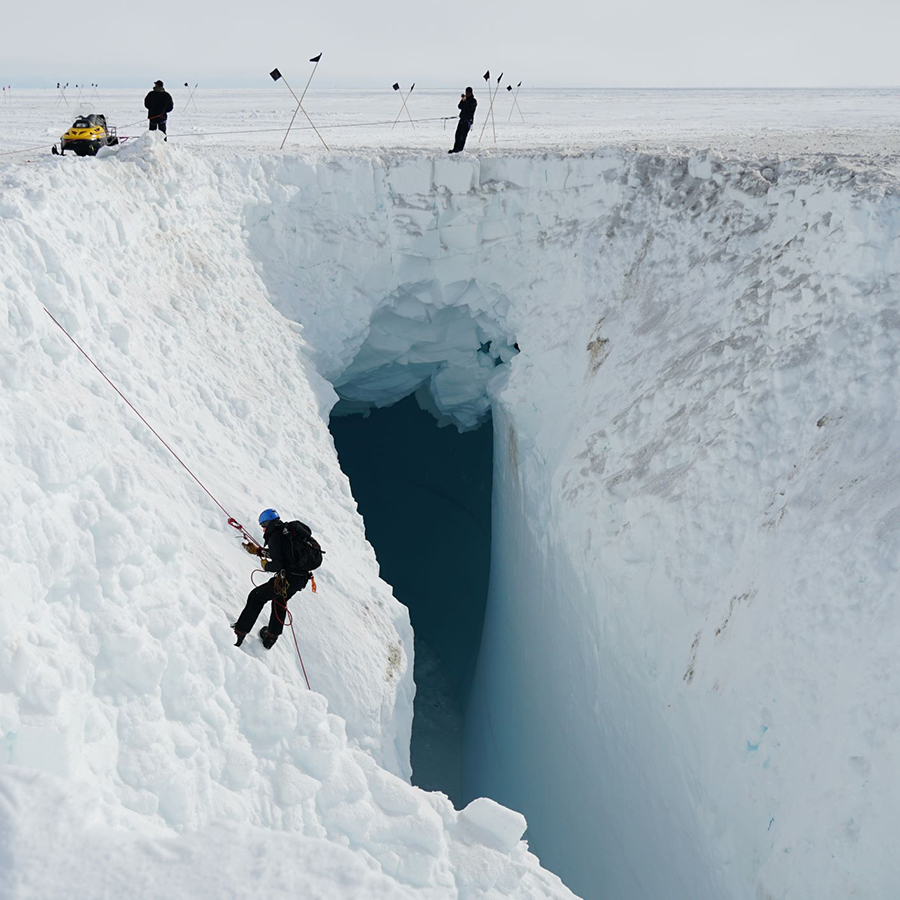 Members of the U.S. Antarctic Program’s South Pole Traverse team rappel down into a crevasse to get a better view. 