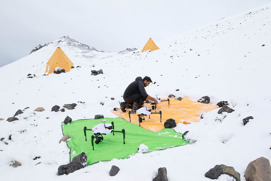 After a recent snowfall, Kunal Shah preps three of the team's AUVs before a mapping flight over the colony. 