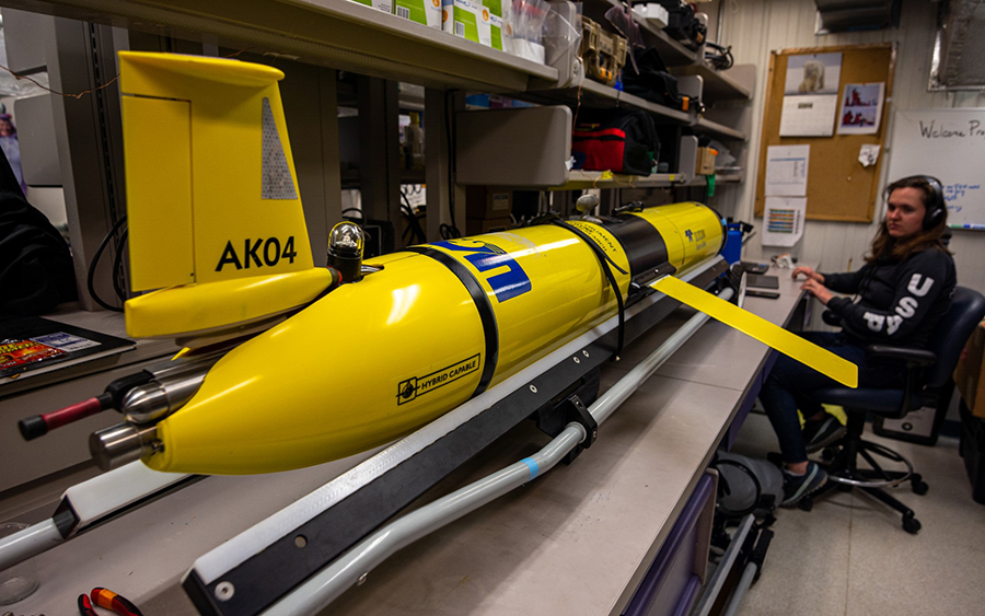 Katie Holmes works on a Slocum glider from the University of Alaska Fairbanks, used to monitor the oceanic conditions around Palmer Station.