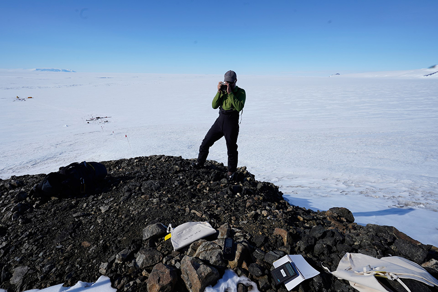 Greg Balco stands atop a rocky outcrop along Mount Murphy, adjacent to Thwaites Glacier. 