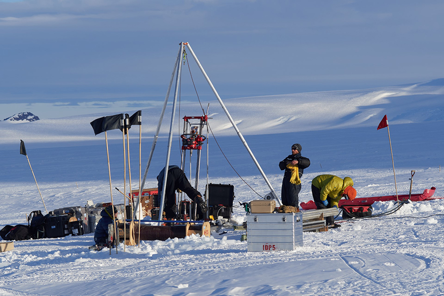 (Left to Right) Elliot Moravec, Grant Boeckman and Seth Campbell operate the ice drill boring through the top layers of the glacier to collect rock cores from beneath the ice. 