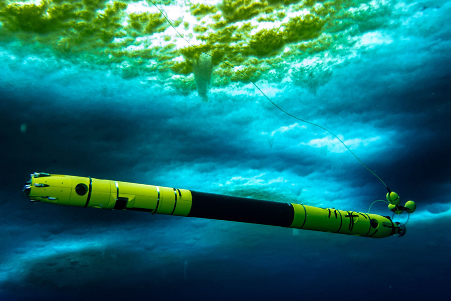 Taken under the sea ice near McMurdo Station, the autonomous underwater vehicle Icefin collects oceanographic data as it swims through the water.