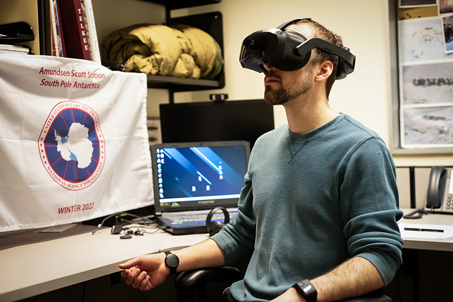 A person tests a virtual reality system indoors at the south pole.