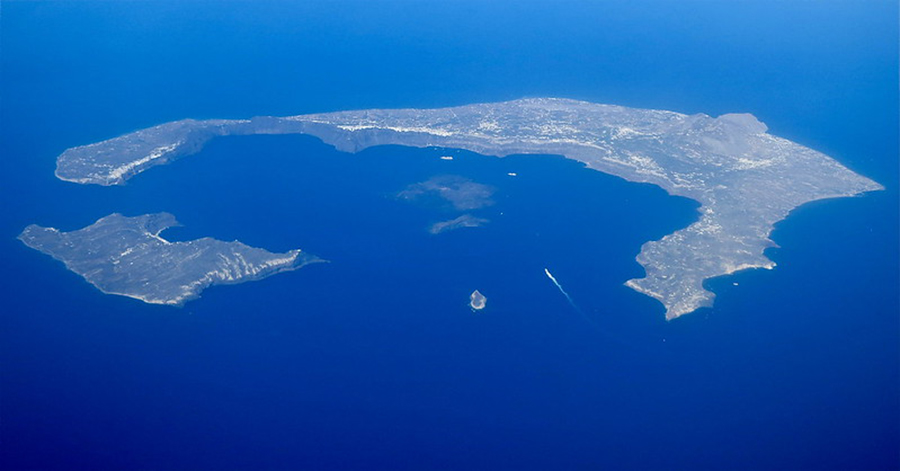 This aerial image shows the Greek islands of Santorini (large) and Therasia (small). The islands are remnants of a larger island called Thera that blew apart during the Minoan volcanic eruption.