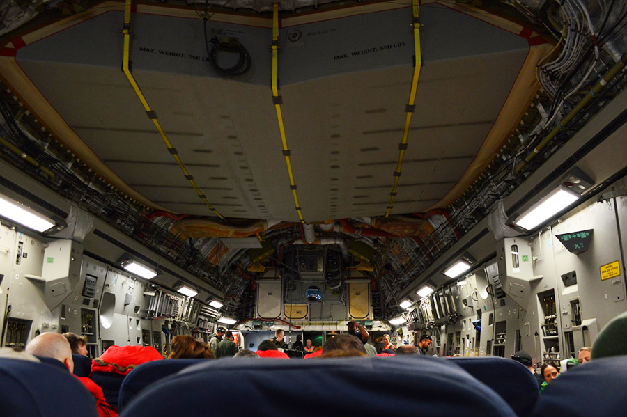 Squeezed inside an Air Force C-17, support staff fly to McMurdo Station on one of the first flights of the season
