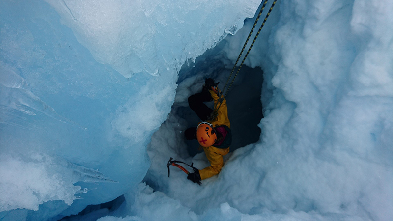 Ground search and rescue team member Carly Quisenberry prepares to climb out of a crevasse at a training for the emergency teams