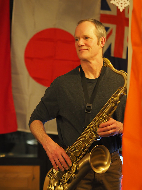 Kris Perry plays the saxophone during Midwinter dinner.