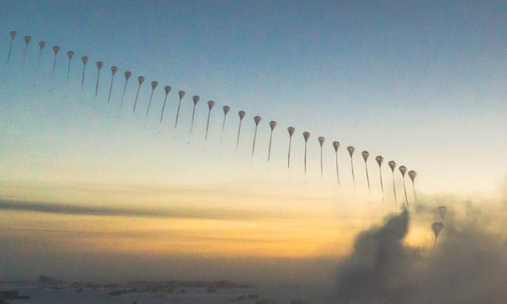In this stitched-together image, a weather balloon drifts off into the distance as the sun dips below the horizon