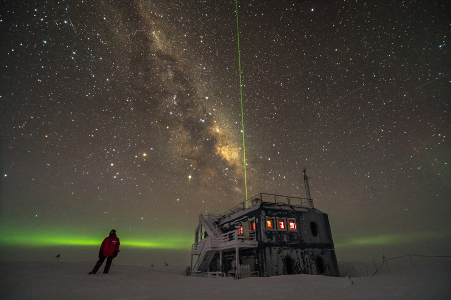With the Milky Way in the background, a green laser shoots into the sky from the Atmospheric Research Observatory, measure atmospheric turbulence