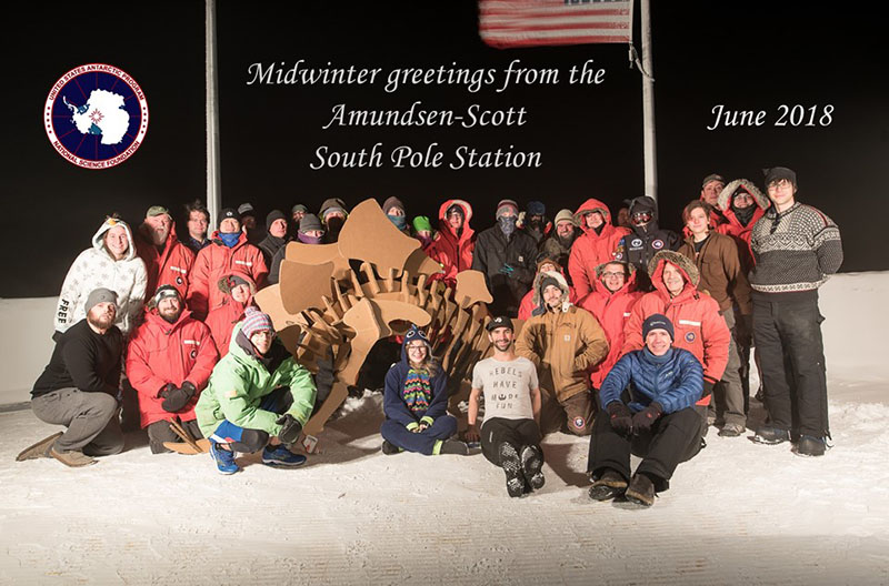 The wintering crew pose for the official South Pole Midwinter photo