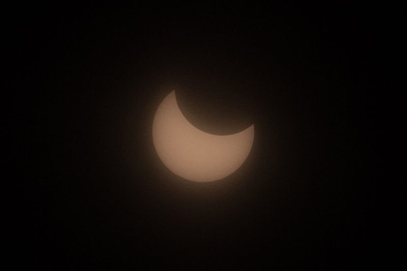 The moon blocks out part of the sun during a partial solar eclipse on February 16th