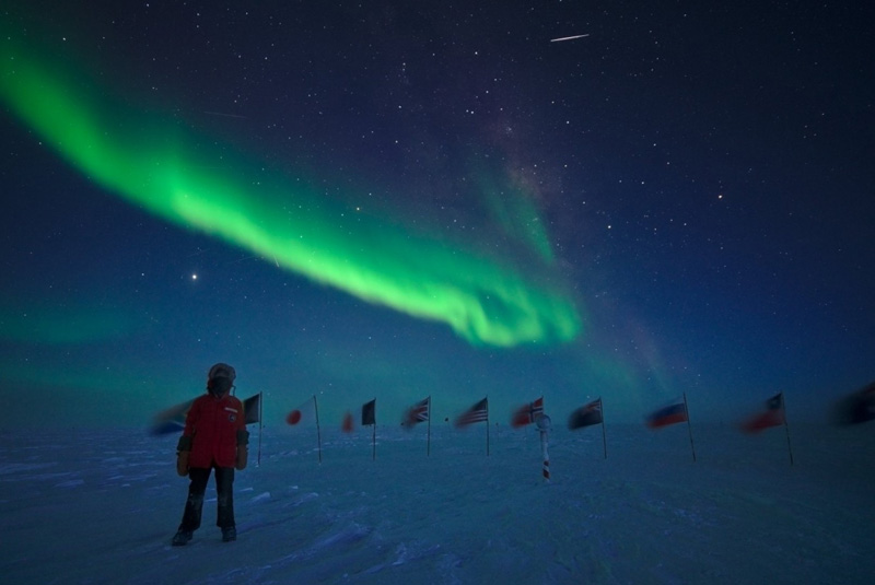 Green aurorae light up the sky above the ceremonial South Pole