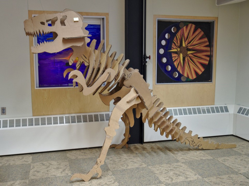 Using spare pieces of cardboard scrounged around the station, residents built a Tyrannosaurus Rex skeleton