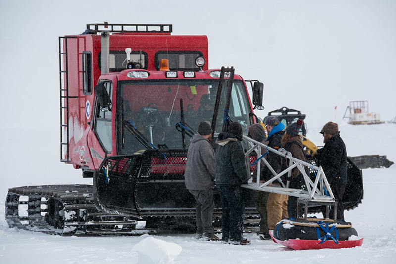 The SPoT team hooks up a boom carrying a ground penetrating radar to the front of a PistenBully tracked vehicle. As the lead vehicle on the traverse, it'll look for dangerous crevasses, snow-covered cracks in the ice that a tractor could fall into.