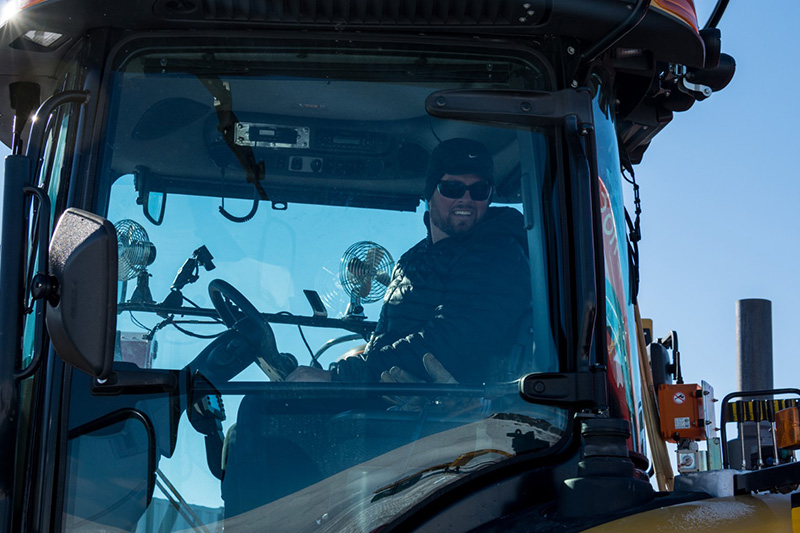 Operator Thor Lossen looks back as he drives his tractor away from the staging area and begins the 1,000-mile journey to the South Pole.